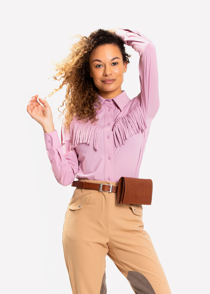Woman in a pink shirt, brown leather belt bag and tan breeches