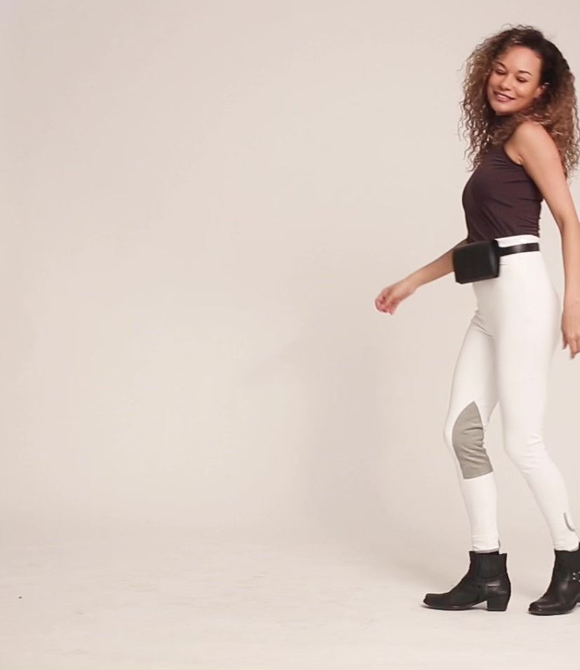 Video of a female model dancing in white high waist riding breeches. 